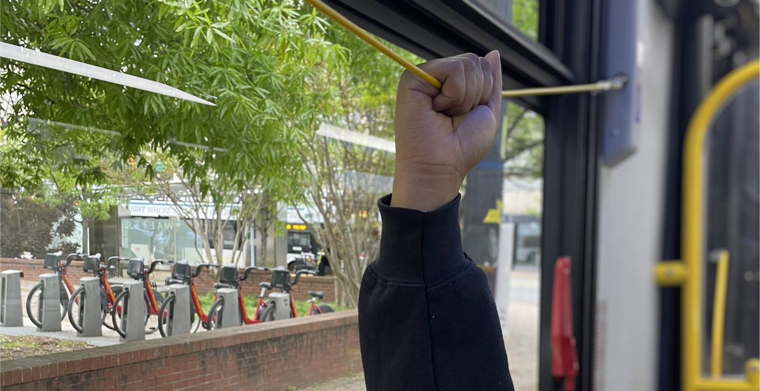 Passenger Pulling yellow cord to request stop on bus